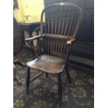 A 19th century stick back ladies' Windsor chair, resting on cross stretcher turned supports.