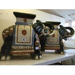 A pair of china garden stools modelled as Elephants.