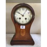 A mahogany cased balloon shaped mantle clock with enamel circular dial.