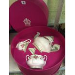 A Royal Albert three piece china gift set comprising a teapot, milk jug and sugar bowl,