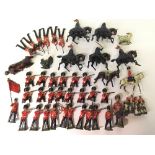 Quantity of lead figures by Britains and others, includes Kneeling Coldstream Guards,