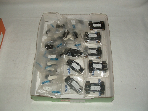 A tray containing new SCALEXTRIC spares - 5 x Motors for Micro Cars with chassis guide, wheels,