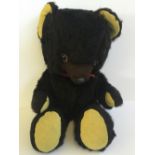 Pedigree (England) Teddy Bear: black with yellow paws, plastic nose and eyes with felt trim.