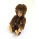 Schuco Miniature Monkey: brown mohair, metal frame, tinplate face, felt pads. Height 9cm.
