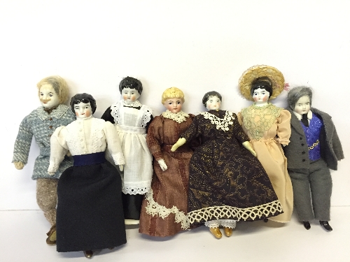 Seven miniature dolls with porcelain shoulder heads and cloth bodies,