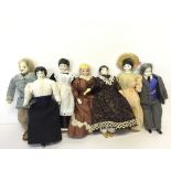Seven miniature dolls with porcelain shoulder heads and cloth bodies,
