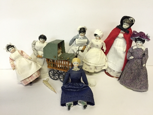 Miniature Doll's Pram of tinplate and wicker construction, with four blue tinplate spoked wheels,