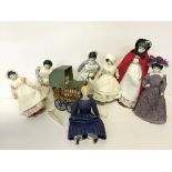 Miniature Doll's Pram of tinplate and wicker construction, with four blue tinplate spoked wheels,