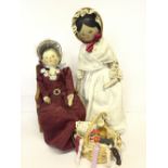 Two Dutch-style wooden Peg Dolls with jointed arms and legs and painted features,
