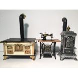 Bodo Hennig (Germany) doll's house miniatures: Kitchen Range; Treadle Sewing Machine; Parlour Stove.
