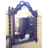 An oak framed wall mirror with barley twist surround.