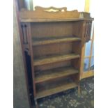 An Arts & Crafts Liberty & Co. style oak four shelf bookcase.