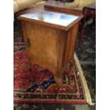 An early 20th century mahogany bedside cabinet (in need of polishing).