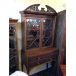 A late 19th century mahogany ladies' secretaire with glazed cabinet and two drawers under.