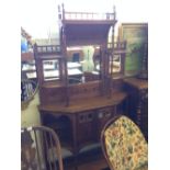 A late 19th century mahogany side cabinet with mirror back, shelving and cupboard under.