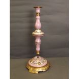 A large C19th Continental porcelain lamp base with a pink ground decorated with gilt scrolls and