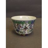 A Chinese porcelain tea bowl with Doucai enamel decoration of fruiting vines and butterflies, 6