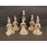 Five unglazed terracotta figures of seated Oriental female musicians, and another standing figure in