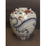 A Chinese blue and white vase with underglazed red flower decoration of a dragon chasing the flaming