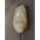 A Chinese mottled jade pendant carved in the form of laughing Buddha, 2½'' long