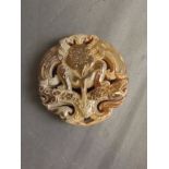 A Chinese pierced and carved jade pendant with mythical creature decoration, 2¼'' diameter