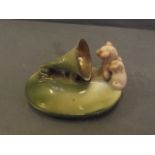 A small green glazed ashtray in the form of a pig fairing, 4½'' wide