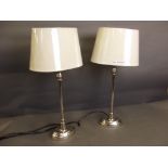 A pair of silvered metal table lamps and shades, 18'' high