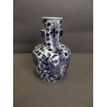 A late C19th/early C20th Chinese blue and white twin handled porcelain vase with painted dragon