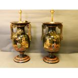 A pair of black ground porcelain twin handled vases painted and gilded with chinoiserie scenes,