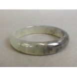 A Chinese marbled grey jade bangle,