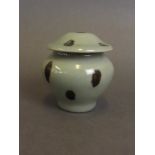 A Chinese green ground porcelain jar and cover with black spotted glaze decoration,