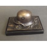 A paperweight in the form of a German military helmet,