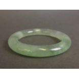 A Chinese apple jade bangle,