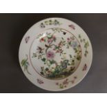 A Chinese porcelain dish with painted enamel decoration of a pomegranate tree,