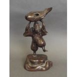 A Chinese bronze figure in the form of a fisherman holding a fish,