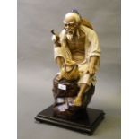 A large Chinese crackle glazed pottery figure of an elderly gentleman holding a pipe,