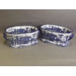 A pair of Victorian Ware blue and white foot baths with transfer printed street scene decoration and