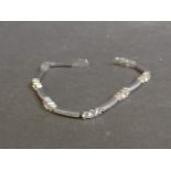 A silver and cubic zirconia set straight line bracelet, 7'' long