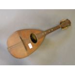 A late C19th six string mandolin, labelled 'Francesco Perretti & Figli, Napoli', 24'' long