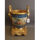 A Sevres style porcelain ice bucket with ormolu mounts and base, with twin cherub mask handles, 13''