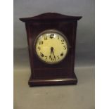 A mahogany inlaid mantle clock with a Gilbert movement, standing on quadruped bun feet, 13'' high