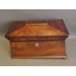 A Regency figured mahogany sarcophagus shaped twin division tea caddy, on bun feet, 13'' wide