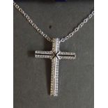 A silver crucifix pendant on a silver chain