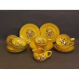 A French yellow ground part pottery tea service decorated with flowers, creamer marked Longcamps,