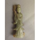 A Chinese olive green jade pendant carved in the form of Quan Yin holding a ruyi, 3½'' high