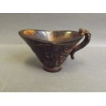 A Chinese buffalo horn libation cup with carved archaic style decoration, 2½'' high