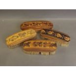 Four Tunbridge ware clothes brushes with floral decoration, 7'' long