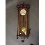 A C19th single weight Vienna wall clock with walnut case and ebonised turnings and mouldings, the