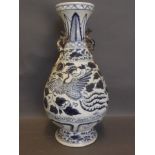 A large Chinese blue and white vase decorated with a phoenix, with twin dragon handles, 14'' high