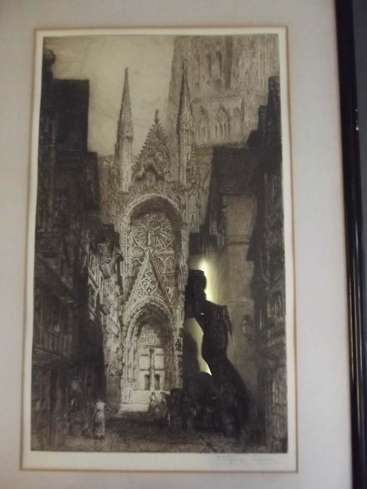 A framed etching of a church, signed Brewer, 21'' x 12''